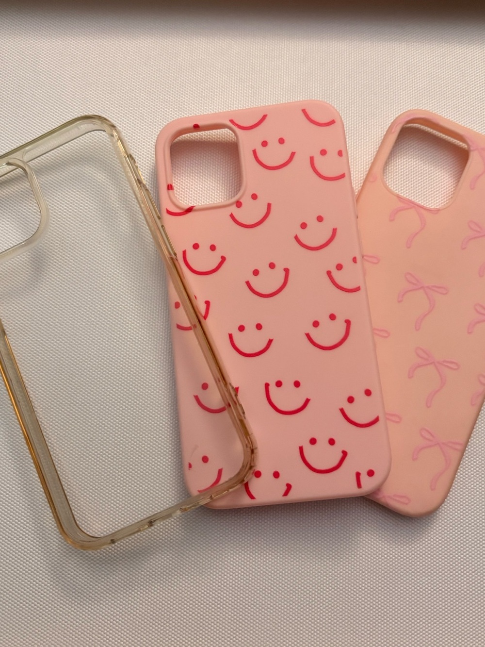 Apple iPhone 12 mini three cases- bows, smiley faces, clear case